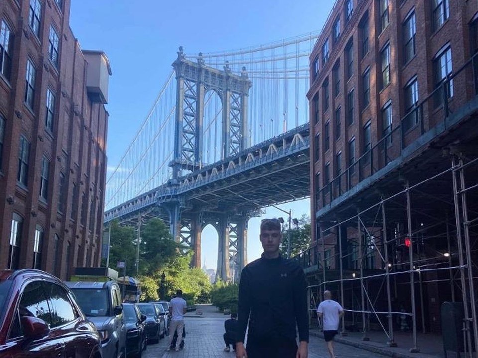 Aaron Michael, standing under the Manhattan Bridge in New York