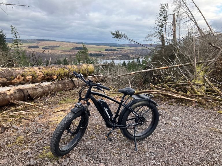A Big Game Bikes Buffalo fat tyre eBike parked on a forestry track above a loch