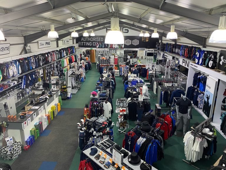 The Clarkes Golf Centre shop floor, racks of clubs, bags and clothing under a pitched roof
